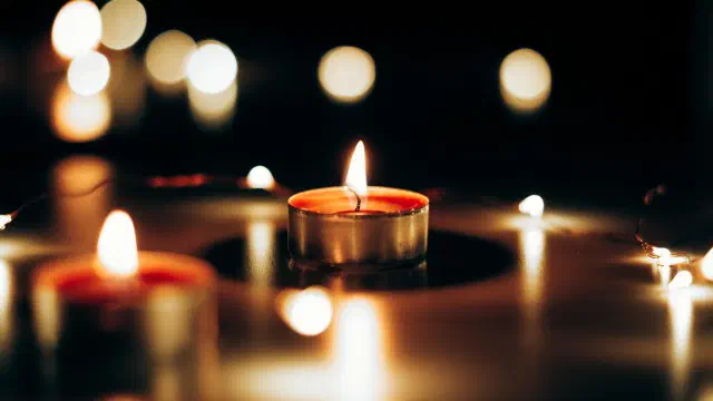 Tea light candles glowing softly in the dark