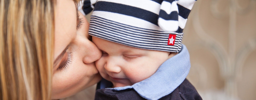 mom kissing baby